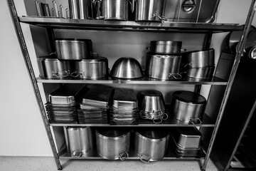 Details with stainless steel kitchen pots, pans and utensils in a professional canteen or hospital...