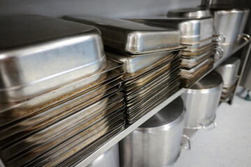 Details with stainless steel kitchen pots, pans and utensils in a professional canteen or hospital...