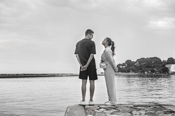 Fototapeta premium A couple in love stands on the seashore. Porec, Istrian Peninsula, Croatia