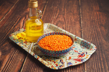 Red lentils and oil on a decorative tray