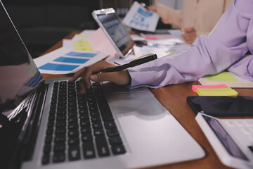 Close up ux developer and ui designer brainstorming about mobile app interface wireframe design on table with customer breif and color code at modern office.Creative digital development agency.