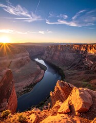 Aerial view of a winding river in a vast canyon at sunrise