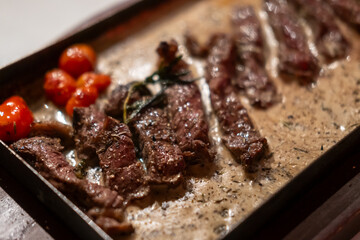 Medium rare grilled meat with gravy sauce on pan