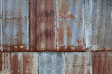 Artistic of old and rusty zinc sheet wall. Vintage style metal sheet roof texture. Pattern of old metal sheet. Rusting metal or siding. Corrosion of galvanized. Background and texture in retro concept © Fauzi Stock