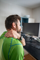 Man with Neck Pain Working at Computer in Home Office