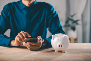 Man uses mobile phone for fintech app, financial piggy bank save money, finance savings pig payment...