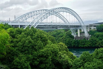 Obraz premium The Shinsaikai Bridge as seen from Saikaibashi Park in Sasebo, Japan going over the Harioseto Strait