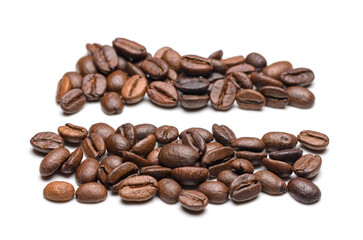 Fototapeta premium Heaps or rows of roasted coffee beans isolated on white background