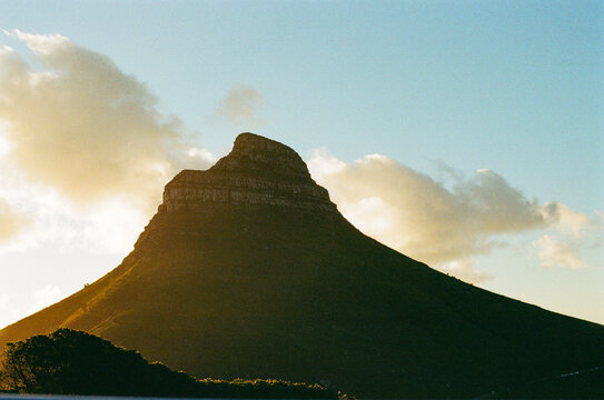 Sunset views silhouette a mountain with a flat peak