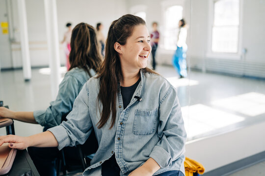 Woman smiling in dance studio reflecting her team