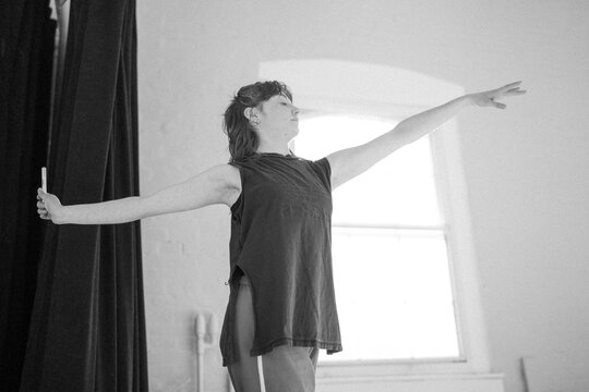 Female dancer practicing ballet movement during rehearsal in studio