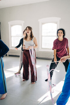 Young women enjoying rhythmic gymnastics training indoors