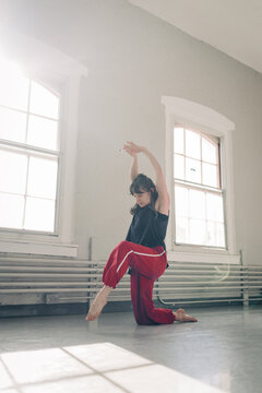 Female dancer performing contemporary movement in studio