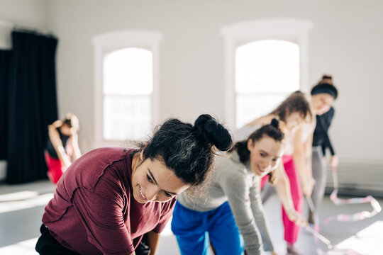 Group of women actively participating in a dance class