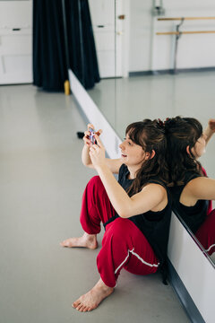 Woman taking cell phone selfie in dance studio