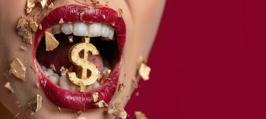 Female lips and teeth biting golden $ USA dollar money symbol, copy space on red background