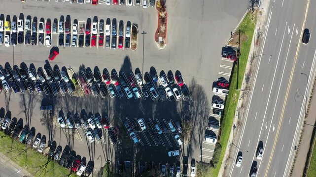 4K aerial drone footage of a busy car dealership parking lot in Beaverton, Oregon, with rows of electric vehicles and auto inventory, showing transportation, retail business, and urban infrastructure