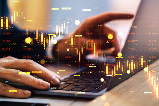 Businessman's hands typing on laptop with financial stock chart overlay showing downward trend and market crash in abstract light background.