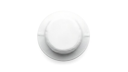 A top view of a plain white plate on a clean surface in a minimalist setting