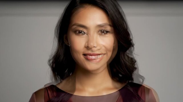 Portrait of a Smiling Young Asian Woman With Dark Hair and Brown Eyes.