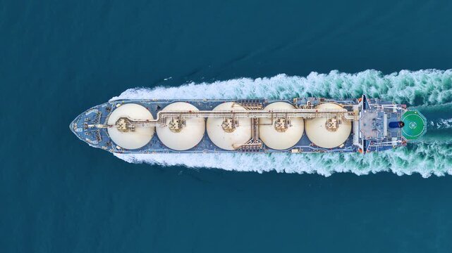LNG tanker ship sailing in the open ocean. Liquefied Natural Gas carrier vessel with white spherical tanks transporting energy fuel. freight transportation shipping Global gas supply logistics.