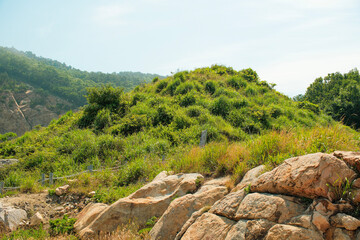 Everyday scenery on Pungdo Island, South Korea, showing small rural structures, green hills, coastal vegetation, and a quiet walking path that reflect