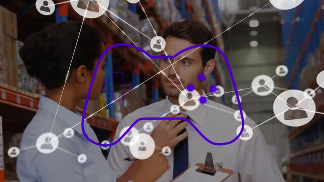 Animation of game controller, connected icons over multiracial coworkers discussing in warehouse