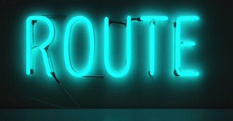 Bright turquoise neon sign spells ROUTE. Dark background emphasizes glowing lettering. Simple design, modern aesthetic.