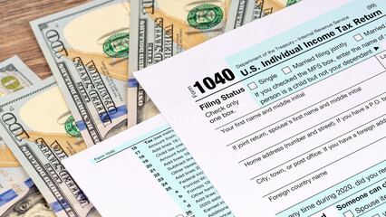 tax return application form with dollar banknotes