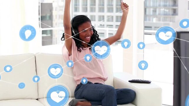 Animation of network of connections with icons over african american woman using headphones