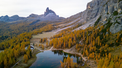 The photo specular landscape of lake Dedera at dolomite in Italy take picture from drone
