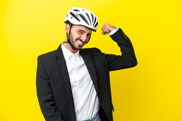 Business caucasian man with a bike helmet isolated on yellow background doing strong gesture