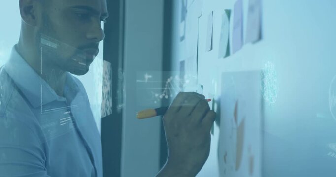 Animation of infographic interface, dna helix over african american man writing on board in office