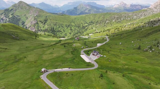 Passo Giau, Giau pass Italy, dolomites. forward drone flight, road on mountain pass. Some cars are driving on the widing road in the Italian Dolomites. Italian mountains. Wild nature. Sunny summer day