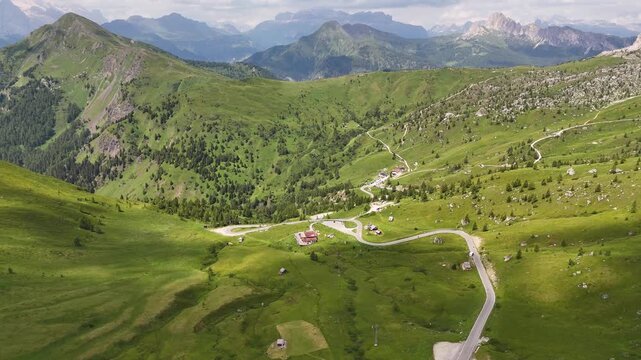 Passo Giau, Giau pass Italy, dolomites. forward drone flight, road on mountain pass. Some cars are driving on the widing road in the Italian Dolomites. Italian mountains. Wild nature. Sunny summer day