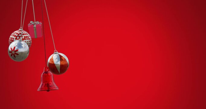 Animation of gift box, bell and baubles swinging against red background