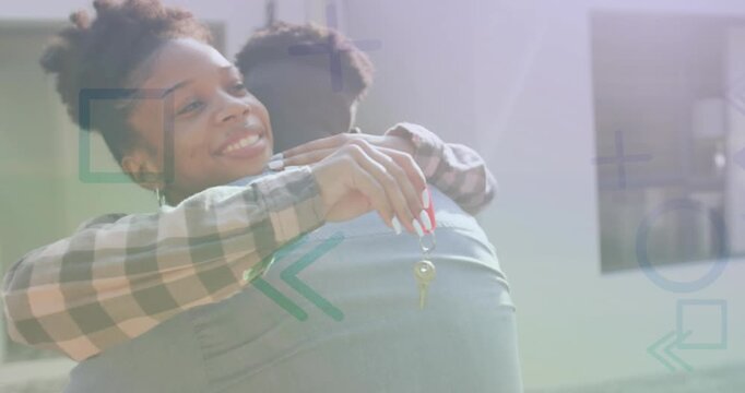Animation of pattern over african american couple with house keys