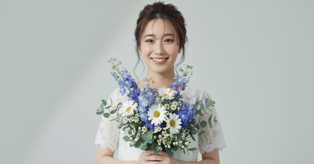 白いレースドレスを着て花束を持つ美しい女性のポートレート	