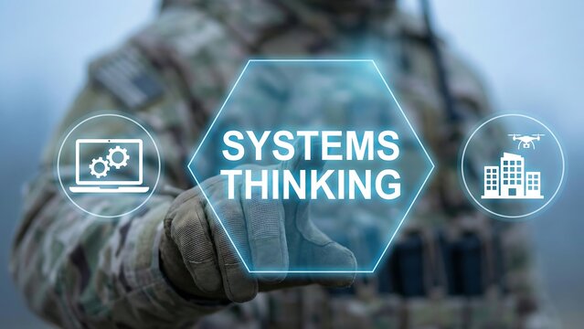 Soldier using virtual touch screen presses the text SYSTEMS THINKING. Systems thinking military concept.  focus on the words