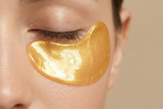 woman wearing gold under eye patch for skincare