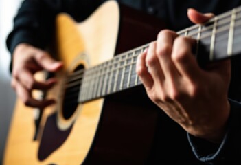 Obraz premium Close-Up of Hands Playing Acoustic Guitar in Soft Lighting