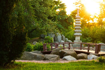idyllic park landscape sunny bright colorful landscape spring season Asian aesthetic region greenery plants and concrete stone landmark pillar heritage object