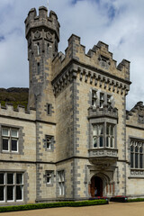 close up view to the architecture of Kylemore Abbey, ireland, with massive stone blocks, doors, and windows