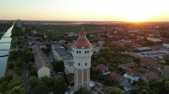 Aerial spinning around the Iosefin Water Tower near the Bega River at sunset, Timisoara, Romania. Recording taken on August 1, 2025.