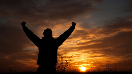 Fototapeta premium A man is standing in a field with his arms raised in the air