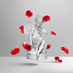 Fototapeta premium Creative art collage of plaster cherub angel statue making silence gesture and floating red rose petals on grey background. Concept of secret love, Valentine's Day and romantic surprise.