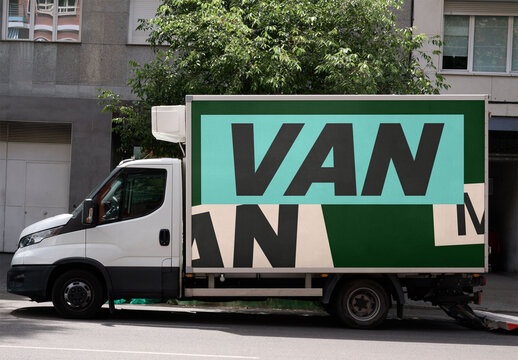 A urban delivery truck mockup stands empty along a street in Barcelona
