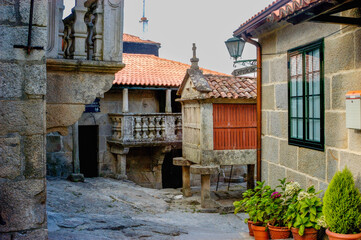 Fototapeta premium A small courtyard with a red building and a white building