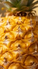 Fototapeta premium Close-up of ripe pineapple with detailed texture and green leaves