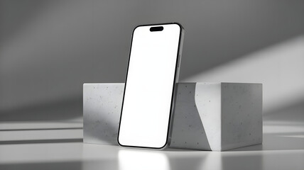 A sleek smartphone with a blank screen is propped up on a modern concrete block in a minimalist setting.